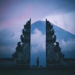 Silhouette at Pura Lempuyang Temple in Bali with Mount Agung in the background at twilight.